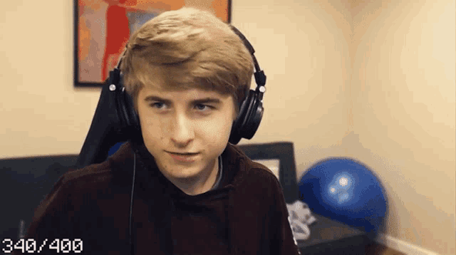 a young man wearing headphones has 340/400 written on the bottom