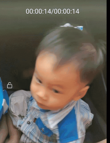 a baby is being held by a person and the time is 00:14