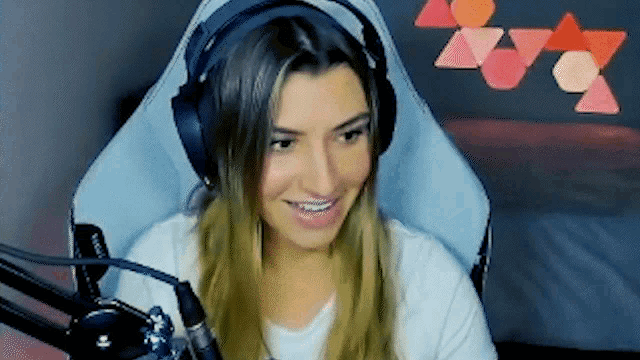 a woman wearing headphones is sitting in front of a microphone