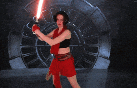 a woman in a red skirt is holding a lightsaber in front of a stormtrooper