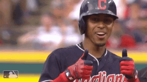 a baseball player with the letter c on his helmet giving a thumbs up