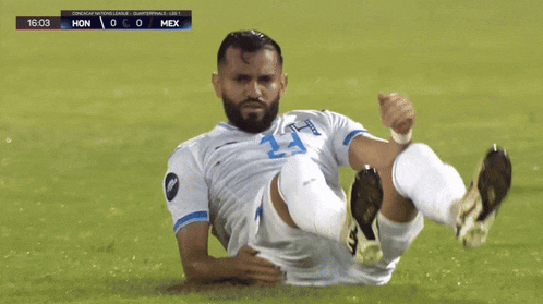 a soccer player with the number 23 on his jersey is on the ground