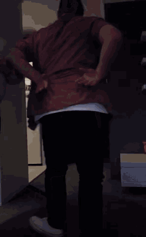 a man in a red shirt and a white shirt with the letter t on it