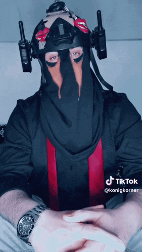 a man wearing a mask and a watch has a tiktok sticker on his wrist