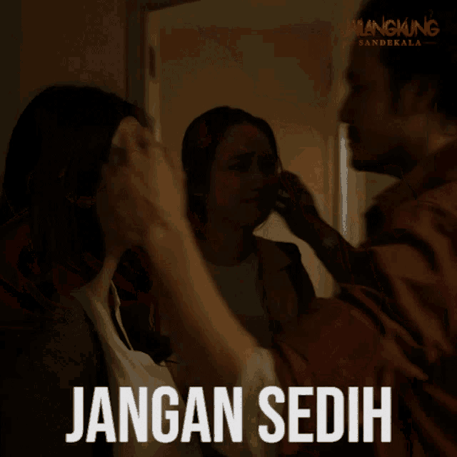 a man and woman hugging with the words jangan sedih written below them