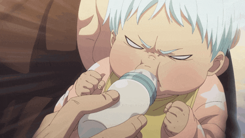 a baby is drinking milk from a bottle with a serious look on his face