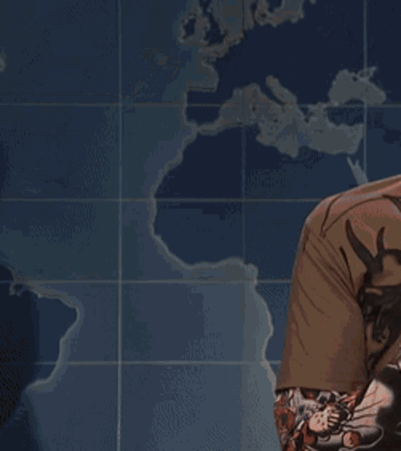 a man holding a black briefcase in front of a map