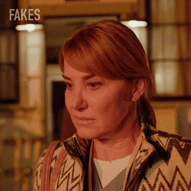a close up of a woman 's face with the words fakes behind her
