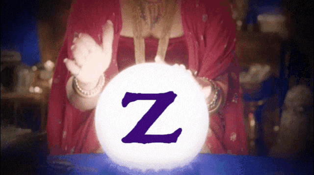 a woman in a red dress is holding a white ball with the letter z on it