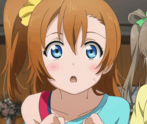 a close up of a girl 's face with orange hair and blue eyes