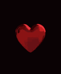 a red heart is spinning on a black background