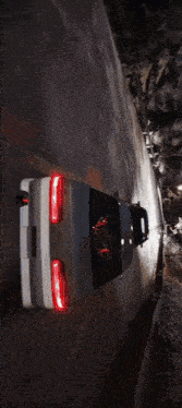 a car is driving down a road with a sign that says ' a ' on it