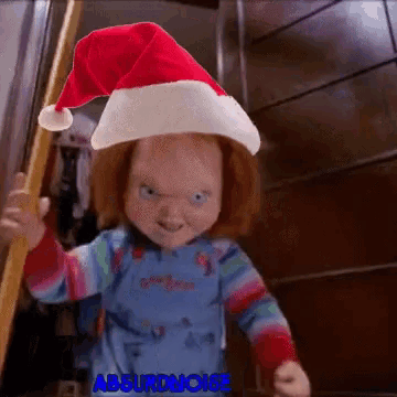 a chucky doll is wearing a santa hat and holding a ladder