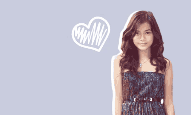 a girl in a strapless dress with a heart behind her