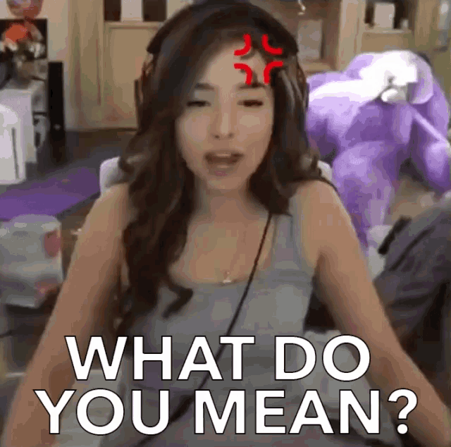 a woman wearing headphones says " what do you mean " in front of a stuffed animal