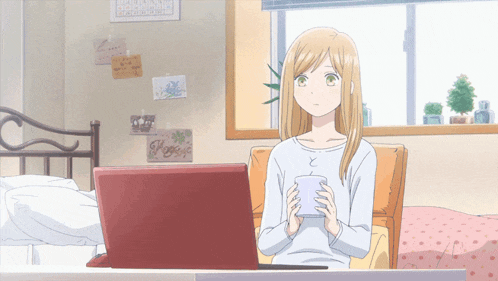 a girl sits in front of a laptop with a sign on the wall that says " hope "