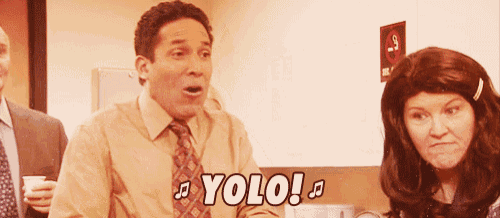 a man in a suit and tie says " yolo " in front of a woman in a wig