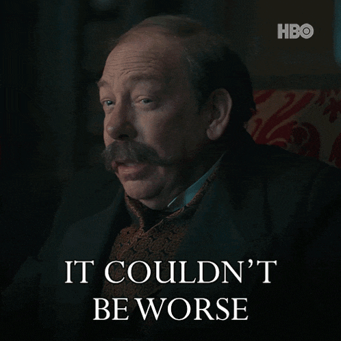 a man with a mustache is sitting in a chair with the words " it couldn 't be worse " below him