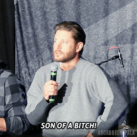 a man speaking into a microphone with the words son of a bitch above him