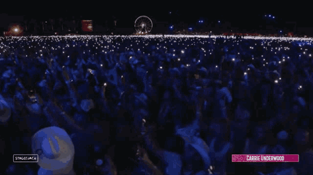 a crowd of people at a concert with the words carrie underwood on the bottom
