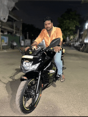 a man is sitting on a black motorcycle with a license plate that says ' tc ' on it