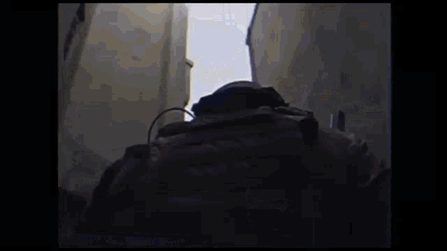 a soldier holding a gun in a dark room