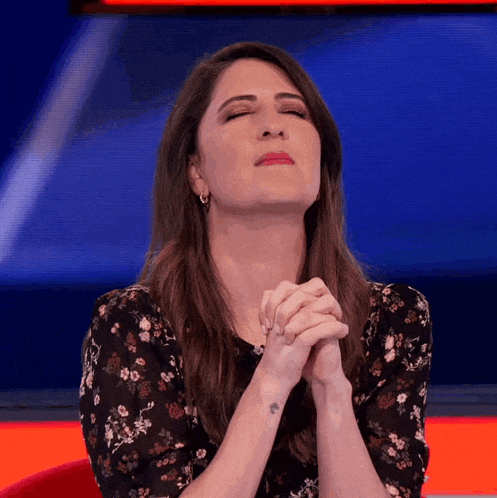 a woman with a tattoo on her wrist is praying
