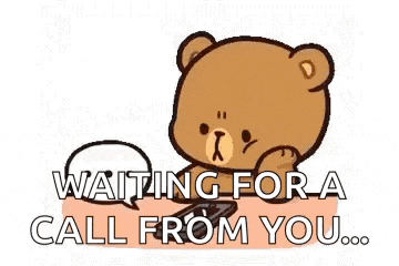a teddy bear is sitting on a table with a speech bubble that says `` waiting for a call from you '' .