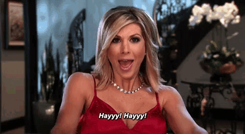 a woman in a red dress is saying hayyy ! hayyy !