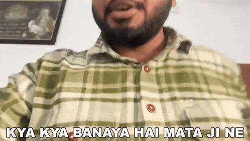 a man with a beard wearing a plaid shirt says " kya kya banaya hai mata ji ne "