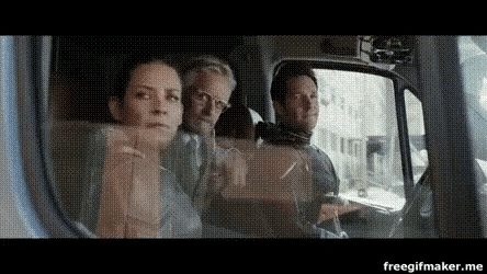 a man and a woman are sitting in the back seat of a truck .