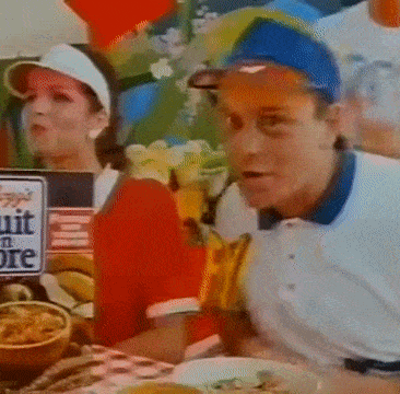 a man and woman are sitting at a table with a sign that says fruit in ore