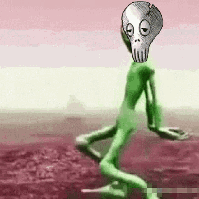 a green alien with a skull on his head is kneeling down in a field .