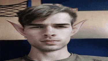 a close up of a man 's face with elf ears on