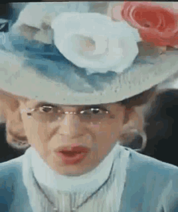 a woman wearing a hat with a flower on it
