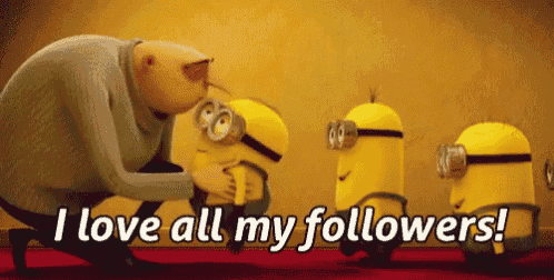a group of minions are standing next to each other and a man is kissing one of them .