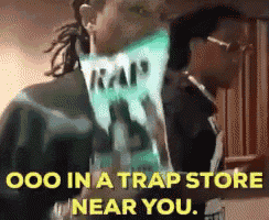 two men are standing next to each other and one of them is holding a bag of traps .