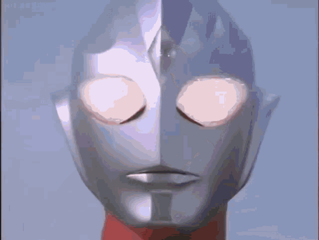 a close up of a cartoon character 's face with his eyes glowing .