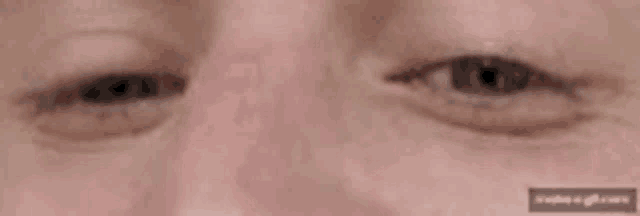 a close up of an older woman 's eyes with a blurred background .