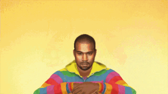 a man in a colorful jacket is holding a rainbow and the word magic is on the front