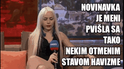 a blonde woman is sitting on a couch with a microphone in her hand and a caption that says novinovka