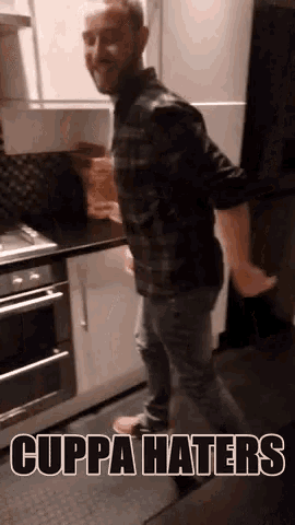 a man is dancing in a kitchen with the words cuppa haters written below him