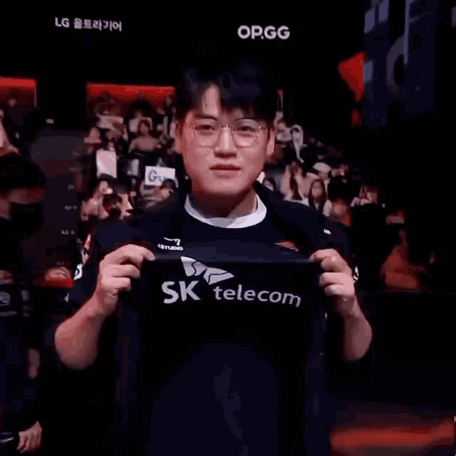 a man wearing a black shirt that says ' sk telecom ' on it