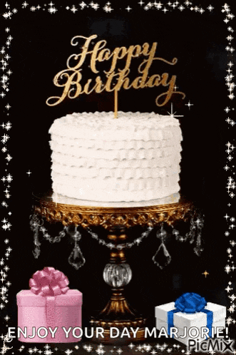 a birthday cake is sitting on top of a cake stand with gifts .
