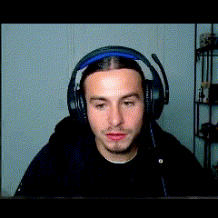 a man wearing headphones with a microphone looks at the camera