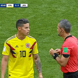 a soccer player wearing a yellow jersey with the number 10 on it is talking to a referee .