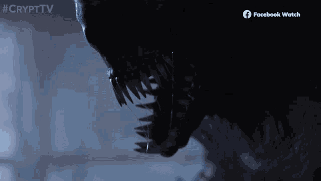 a close up of a monster 's mouth with a facebook watch logo on the bottom