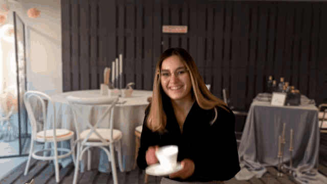a woman holding a cup of coffee in front of a sign that says ' do not enter '