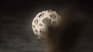 a person is standing in front of a large moon