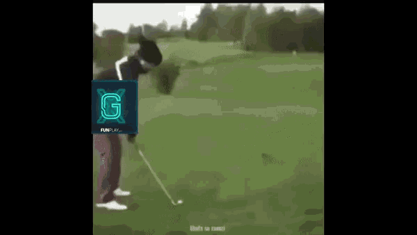 a man is swinging a golf club on a golf course and the letter g is on the screen behind him